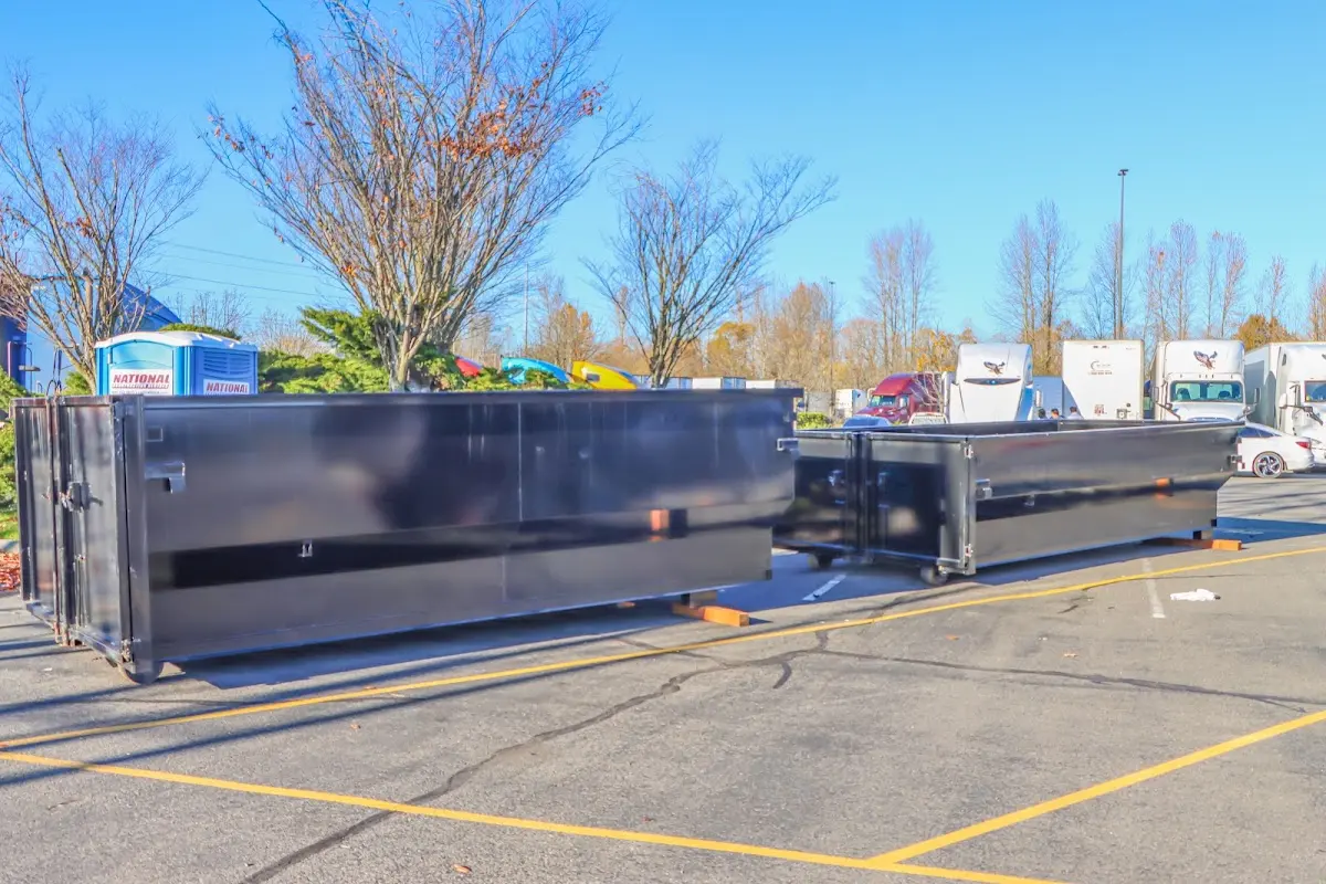 Professional dumpster rental service with roll-off container on residential driveway in Streator